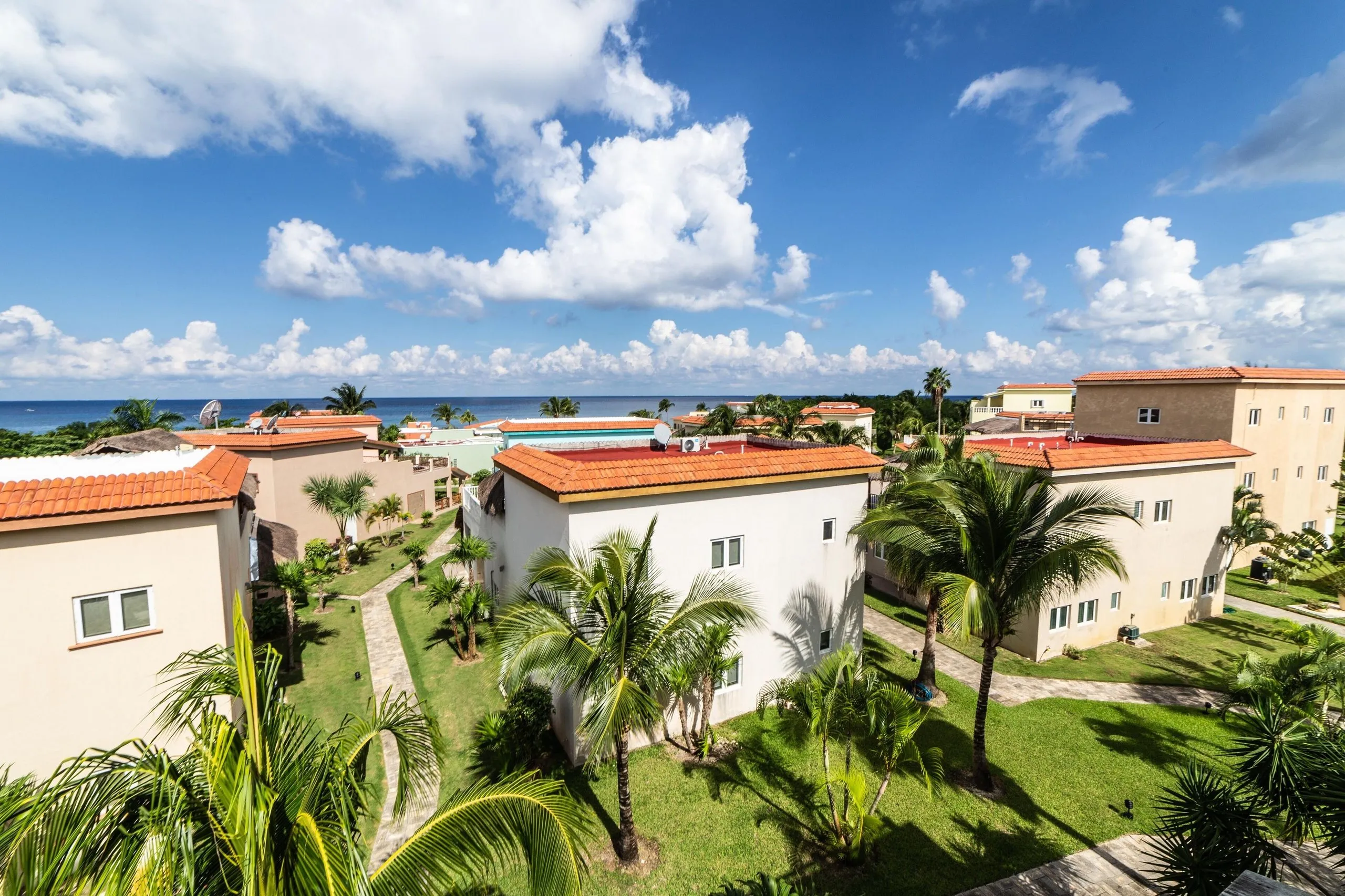 The Costa del Sol gated beachfront community in Cozumel seen from above, showing the villas, palms and shoreline