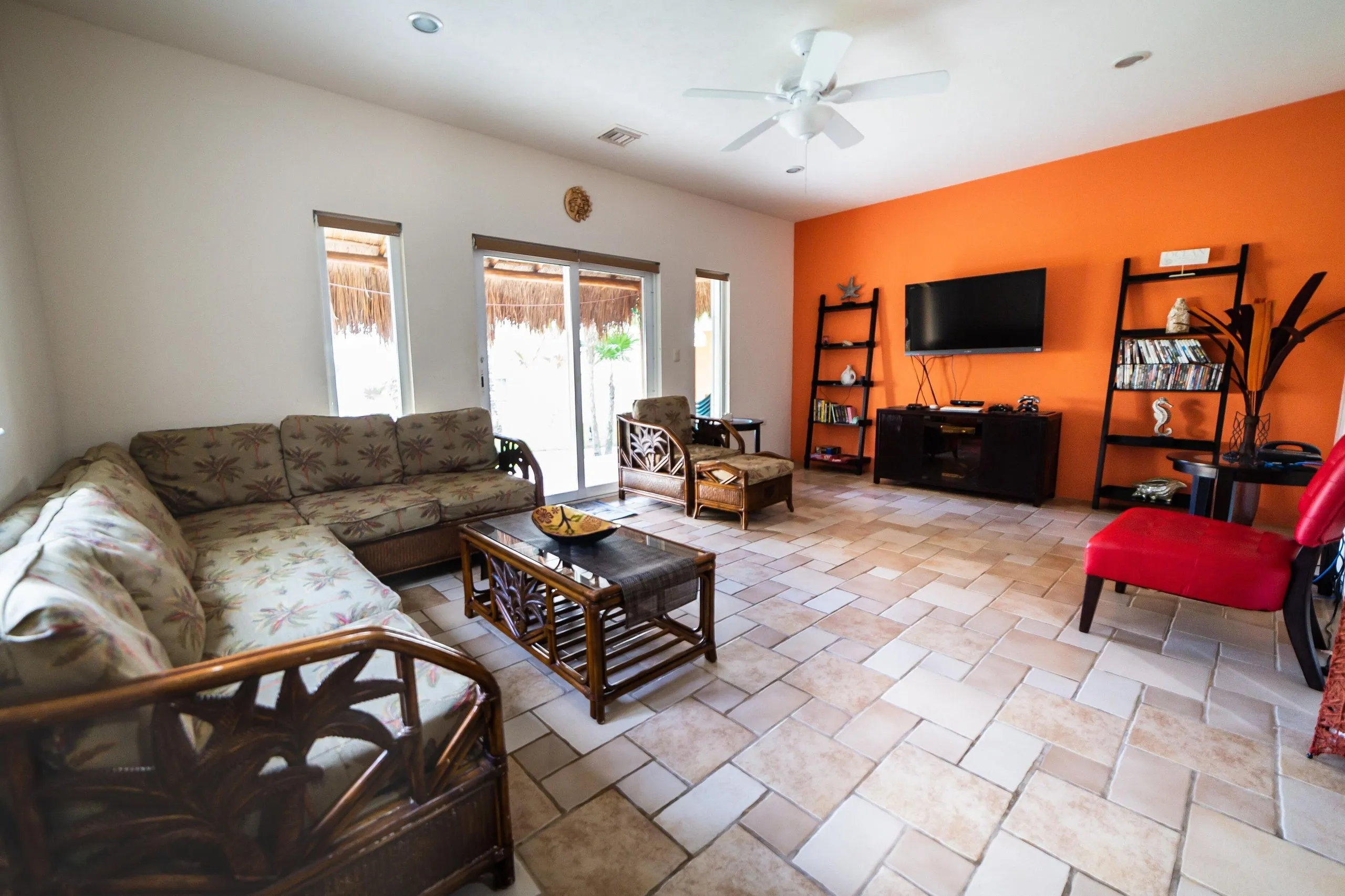 Living area with sofa, armchairs, coffee table and bookshelves