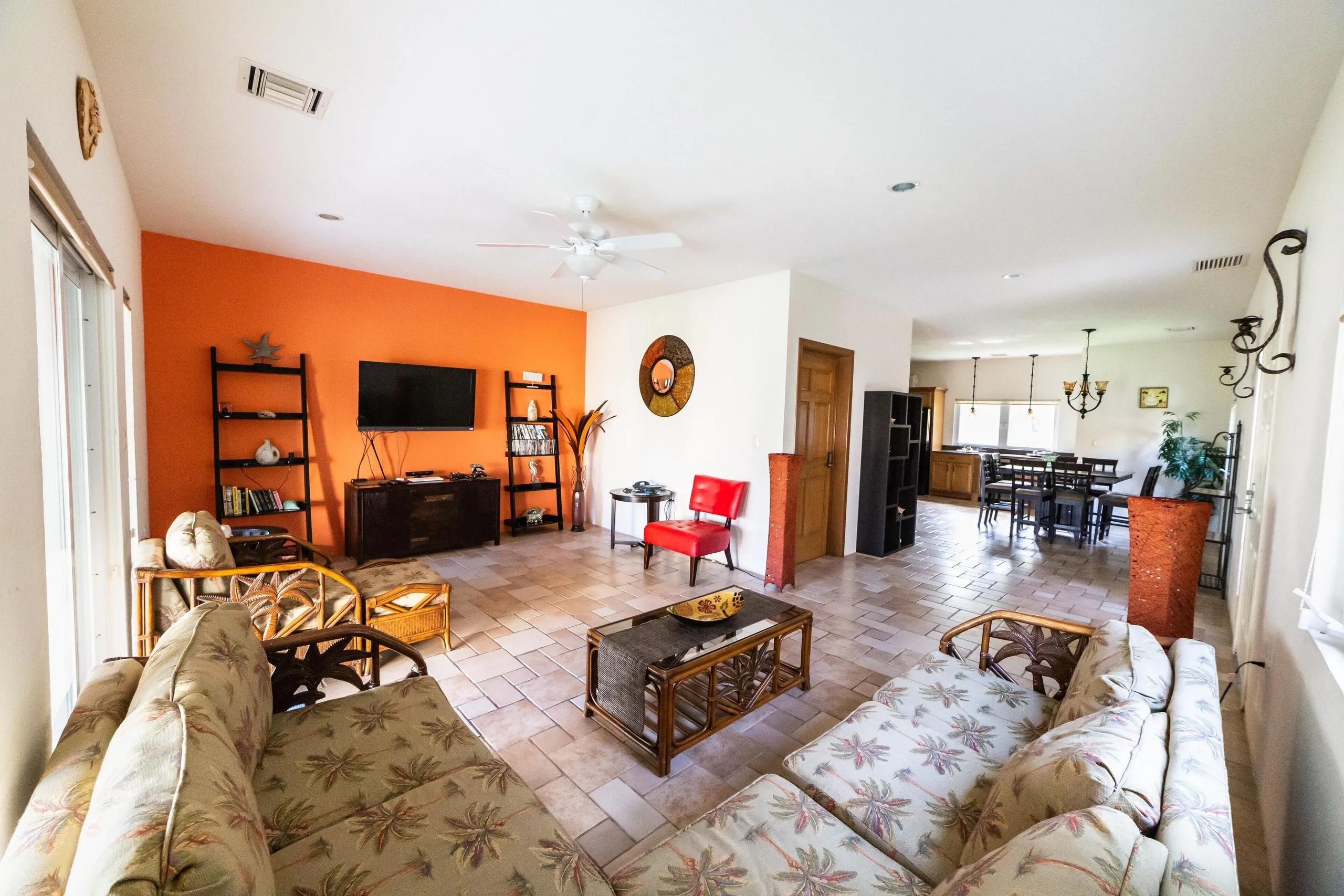 Living room at Casa Dana with a sofa, coffee table, television and a filled bookshelf